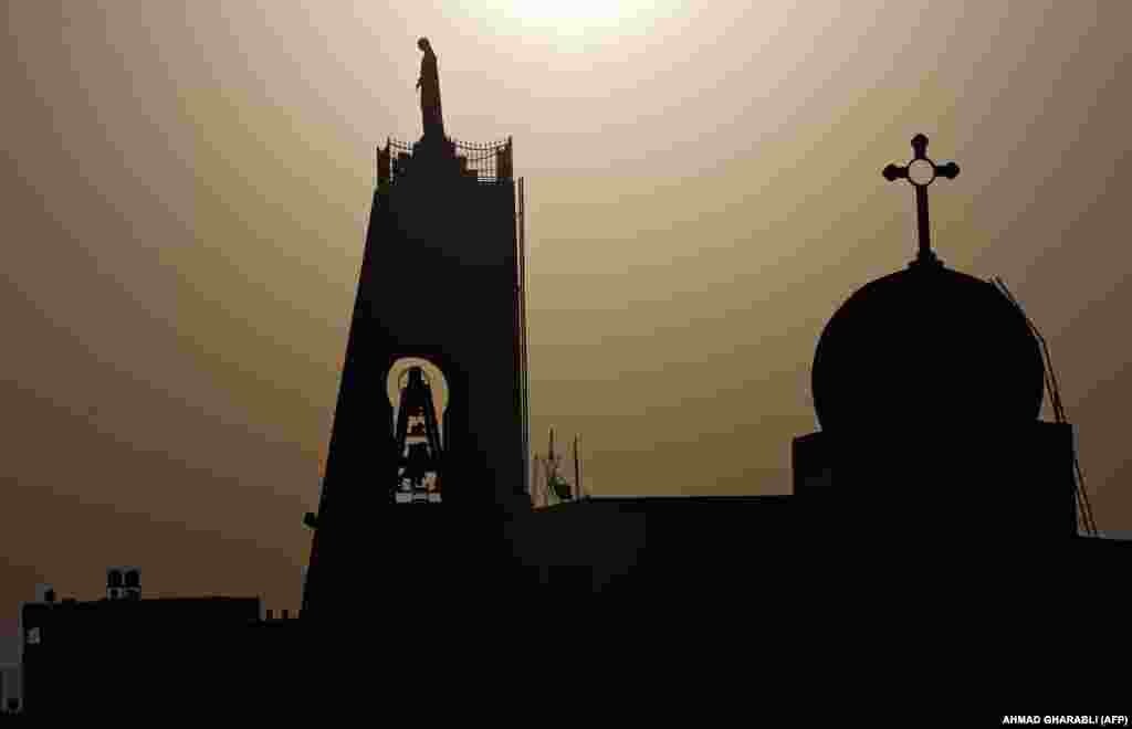 The sun sets behind the Maronite Church of the Annunciation in Nazareth in northern Israel. (Ahmad Gharabli)