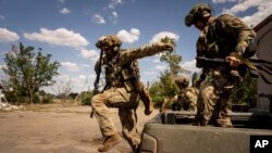 Ukrainian soldiers from a reconnaissance team take up positions at the front line in southern Ukraine last month. 