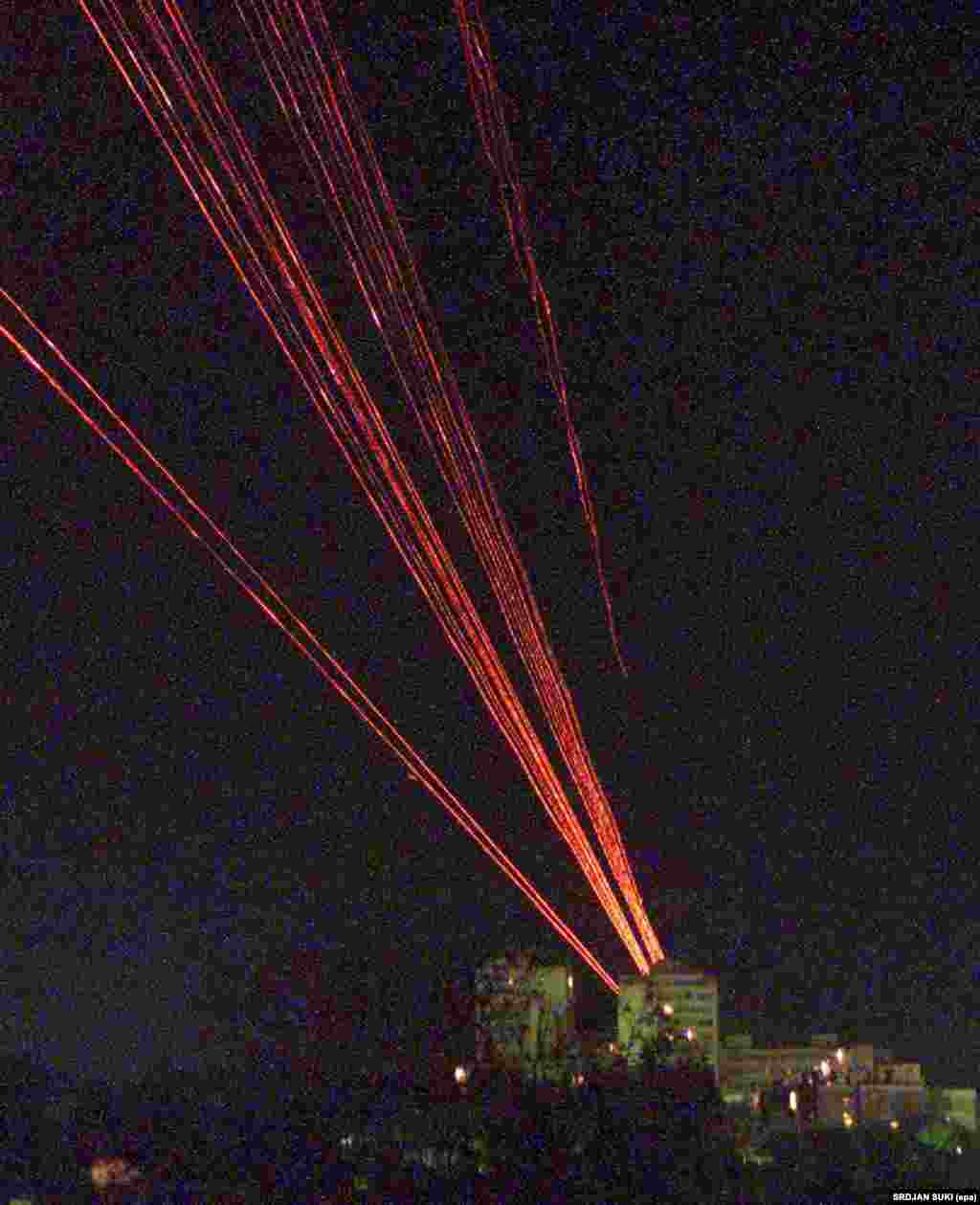 Tracer bullets from Yugoslav Army antiaircraft guns streak into the sky above Belgrade as NATO air strikes on Yugoslavia were launched in 1999. &nbsp;