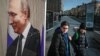 Russians walk near a large photograph of Russian President Vladimir Putin in the center of Moscow.