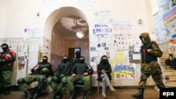 Protesters during their evacuation of Kyiv's city administration building on February 16.