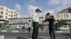 A police officer advises an Iranian man to wear a face mask after Iranian authorities made it mandatory for all to wear face masks in public following the outbreak of the coronavirus disease (COVID19), in Tehran