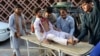 Volunteers carry an injured man on a stretcher to a hospital following the suicide bombing in Nangarhar on June 16.