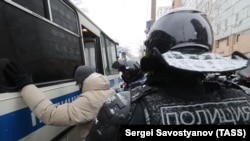 Riot police detain a participant in an unauthorized protest in support of Aleksei Navalny in central Moscow on January 31. 