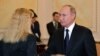 Russian President Vladimir Putin presents posthumous awards to the widows of victims of the Nyonoksa radiation accident at a ceremony in Moscow on November 21. 