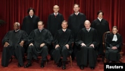 Associate Justice Antonin Scalia (2nd left, front row) sits among the other justices of the U.S. Supreme Court for a group portrait in Washington in October 2010.