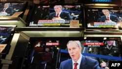Televisions show former Prime Minister Tony Blair giving evidence to the Iraq War Inquiry in London today.