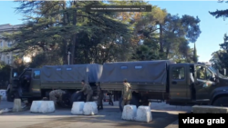 Military vehicles and soldiers in Sukhumi, near the site of standoff, on November 16