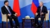 Russian President Vladimir Putin (right) speaks with Chinese President Xi Jinping during their meeting on the sidelines of the Eastern Economic Forum in Vladivostok on September 11.