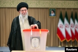 Iranian Supreme Leader Ayatollah Ali Khamenei casts his vote during the presidential runoff election in Tehran on July 5.