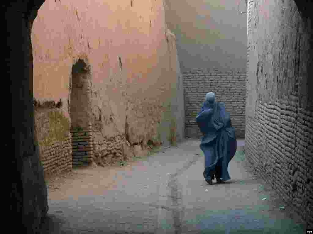 A woman walks on a street of Herat, Afghanistan. Photo by Jalil Rezayee for epa