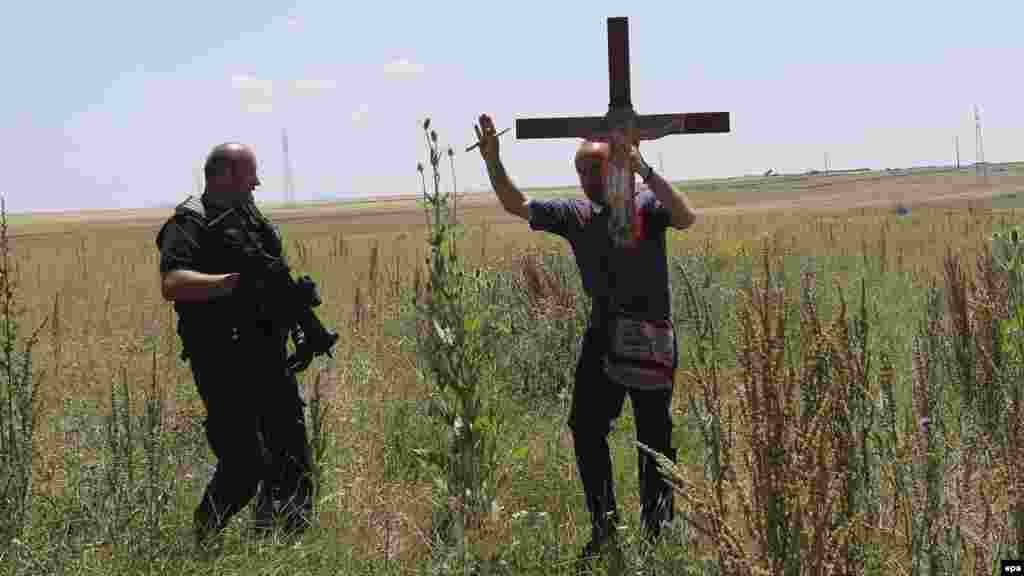 A police officer prevents an ethnic Serb from using a secondary road on his way to celebrate St. Vitus Day in Gazimestan.