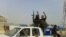 A screen grab taken from a video uploaded to YouTube on June 17 allegedly shows militants ISIL parading with their weapons in the northern Iraqi city of Baiji. 