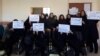 Iranian teachers protest in Alborz Province on March 4. They are holding signs expressing dissatisfaction with hyperinflation and low wages. 