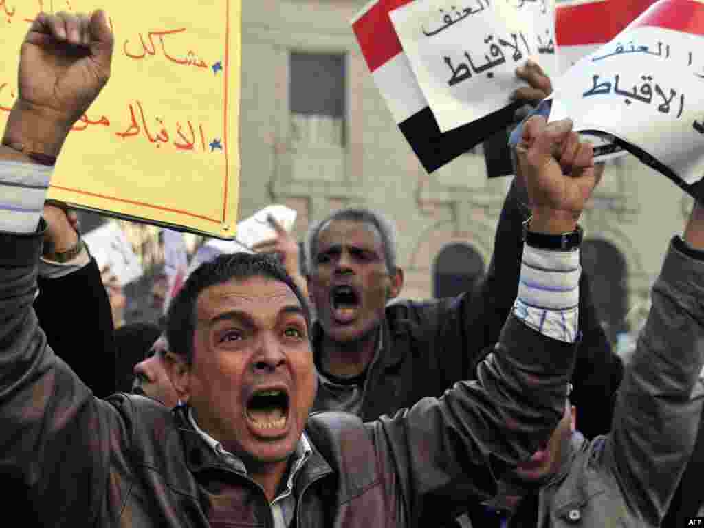 Egyptians in Cairo protest against deadly violence targeting Coptic Christians in the town of Nagaa Hamady. - Egyptian Muslims and Christians rioted and set fire to homes and shops in the wake of the drive-by shooting attack that killed six on Orthodox Christmas. Photo by AFP