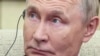 Russian President Vladimir Putin listens to a headphone translation in Beijing.