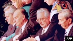 Warren Christopher (right) is present as Slobodan Milosevic (left to right), Alija Izetbegovic, and Franjo Tudjman initialize a peace accord between their countries at the conclusion of talks near Dayton, Ohioh, in 1995.