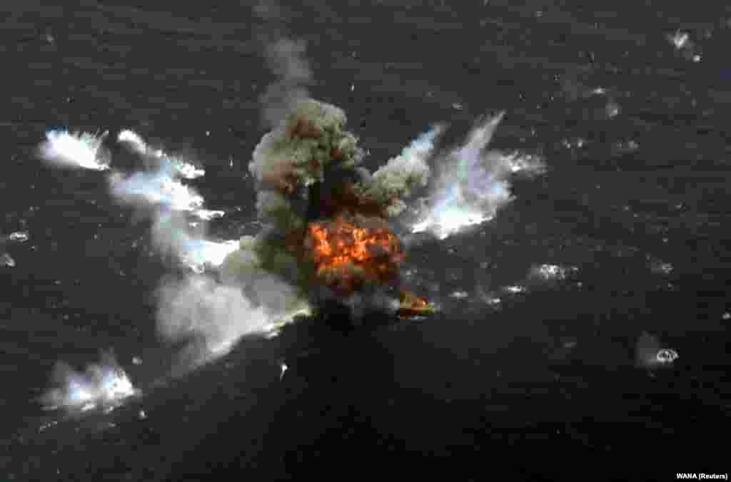 An explosion is seen after a new Iranian-made cruise missile was fired during war games in the northern Indian Ocean, near the entrance to the Gulf, on June 17. (WANA via Reuters)