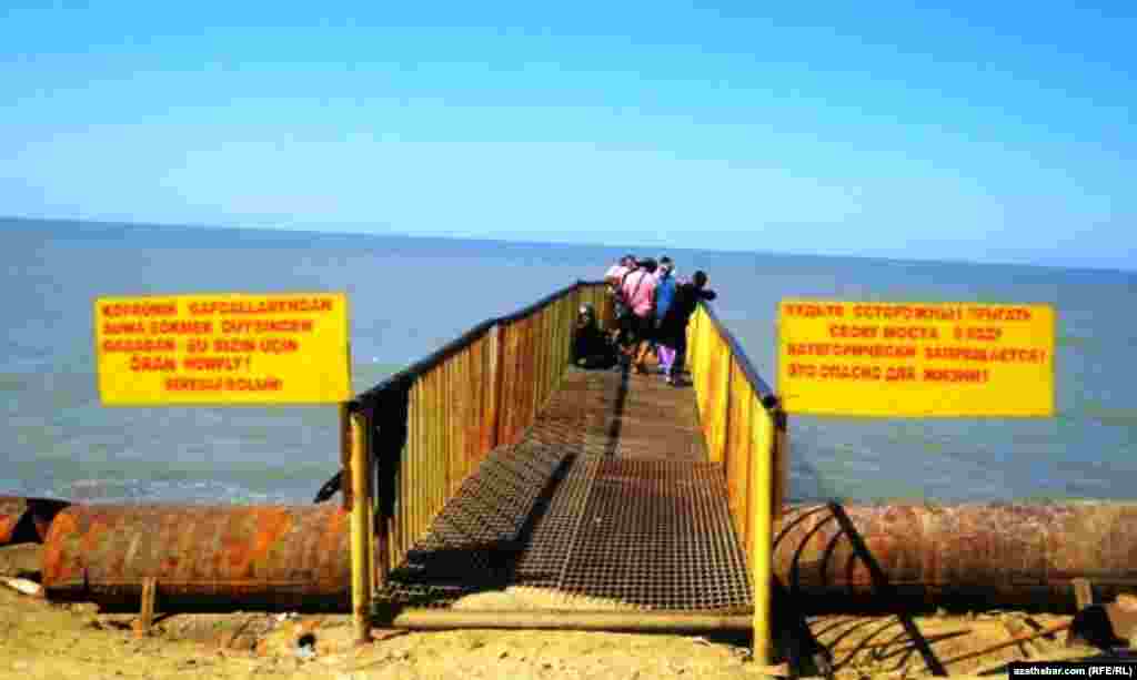 Signs warn about the lethal dangers of diving into this section of the Caspian Sea.