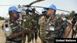 Patrick Nyamvumba (right), commander of the African Union-UN Hybrid Operation in Darfur (UNAMID), arrives in West Darfur to investigate the June 21 ambush on Rwandan peacekeepers that left three dead.