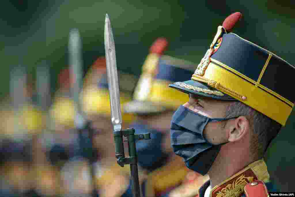 Romanian honor guards stand at attention during a ceremony at the Aviation Heroes&#39; monument in Bucharest. Aviation Day on July 20 celebrates aviators, both military and civilian, who lost their lives in the line of duty or contributed to the evolution of Romanian aviation. (AP/Vadim Ghirda)