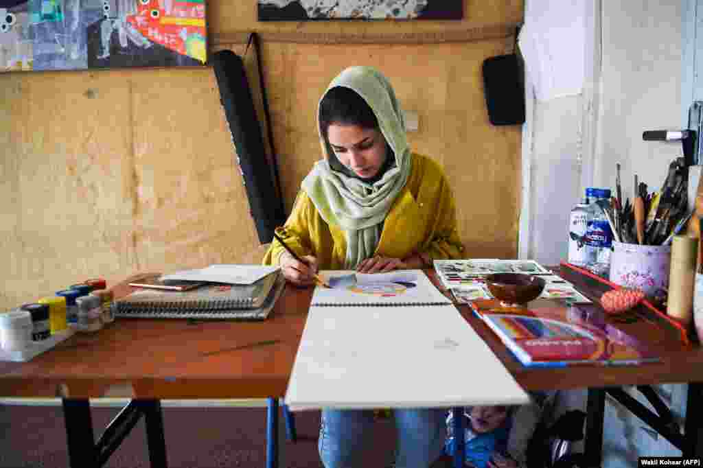 Before: An artist works in her studio in Kabul in August 2019.