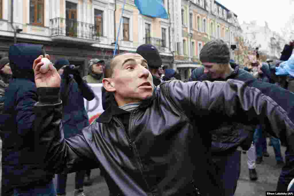 Ultraright activists throw eggs and stones at the windows of a Russian cultural center in Kyiv on February 18. (AP/Efrem Lukatsky)