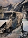 Burned vehicles parked near a civilian building following drone attacks on the Kyiv region on May 18