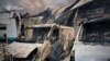 Burned vehicles parked near a civilian building following drone attacks on the Kyiv region on May 18