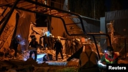 Rescuers work at the site where a building was destroyed during a Russian missile strike on Zaporizhzhya on August 9.