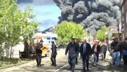 Російські посадовці на тлі палаючого НПЗ у Туапсе після українського удару 28 квітня 2026 року