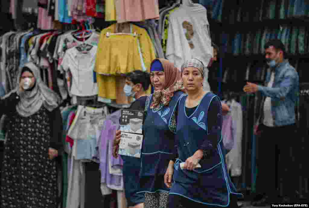 Migrant laborers work in a market in Moscow.