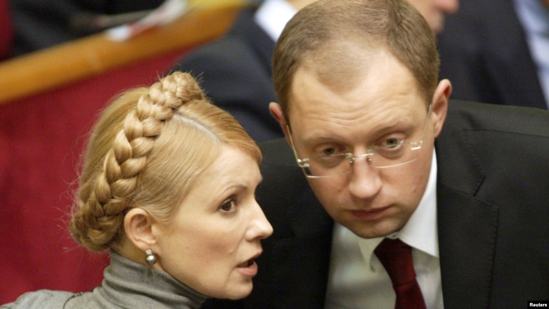 Then-Foreign Minister Arseniy Yatsenyuk chats with Yulia Tymoshenko in the Ukrainian parliament in Kyiv in 2007.