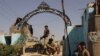 Afghan security forces stand guard at the main gate of the prison, after retaking Kunduz from the Taliban, in Kunduz in October 2015.