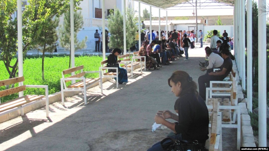 A crowd of people wait in line outside the offices of Turkmenistan's Migration Service in the eastern city of Turkmenabat in Lebap Province.