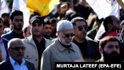 Former Iraqi militia commander Abu Mahdi al-Muhandis and Iraqi Shiite militia supporters march outside the U.S. Embassy during a protest in Baghdad, days before he was killed, 31 December 2019