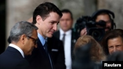 Canadian Prime Minister Justin Trudeau greets other mourners as he arrives at the funeral of the Aga Khan in Lisbon on February 8. 