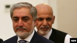 Afghan presidential candidates Abdullah Abdullah (L) and Ashraf Ghani (R) attend a ceremony after signing a power-sharing agreement at the Presidential Palace in Kabul, Afghanistan, 21 September 2014. 