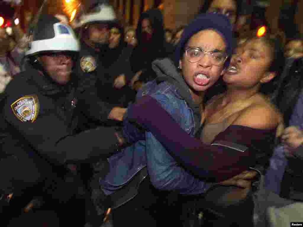 Members of the Occupy Wall Street movement clash with New York Police Department officers after being removed from Zuccotti Park in New York on November 15. (REUTERS/Lucas Jackson)