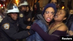 Members of the Occupy Wall Street movement clash with New York police after being removed from Zuccotti Park in New York on November 15.