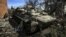 UKRAINE – This photograph taken on March 28, 2022, shows an abandoned Russian armoured vehicle in the village of Mala Rogan, east of Kharkiv, after the Ukranian troops retaking it.