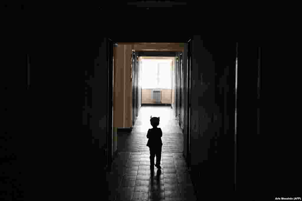 A child walks in a corridor at a university student residence in Yerevan, Armenia. The residence is used for people who were displaced in recent fighting over Nagorno-Karabakh. (AFP/Aris Messinis)&nbsp;&nbsp; &nbsp;