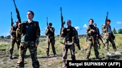 Female Ukrainian cadets present military uniforms designed specially for women on the outskirts of Kyiv in July 2023.