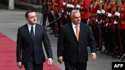 Georgian Prime Minister Irakli Garibashvili (left) and visiting Hungarian Prime Minister Viktor Orban attend a welcoming ceremony in Tbilisi on October 11.