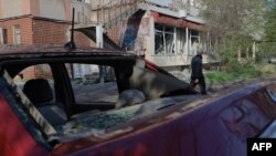 A man walks past a damaged building following a Russian drone strike in Odesa on April 22. 
