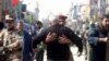 Iraqi soldiers search civilians ahead of the start of Ashura