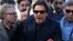 Imran Khan gestures as he addresses members of the media after Pakistan's Supreme Court dismissed a petition to disqualify him from parliament for not declaring assets, outside Jinnah International Airport in Karachi on December 15.
