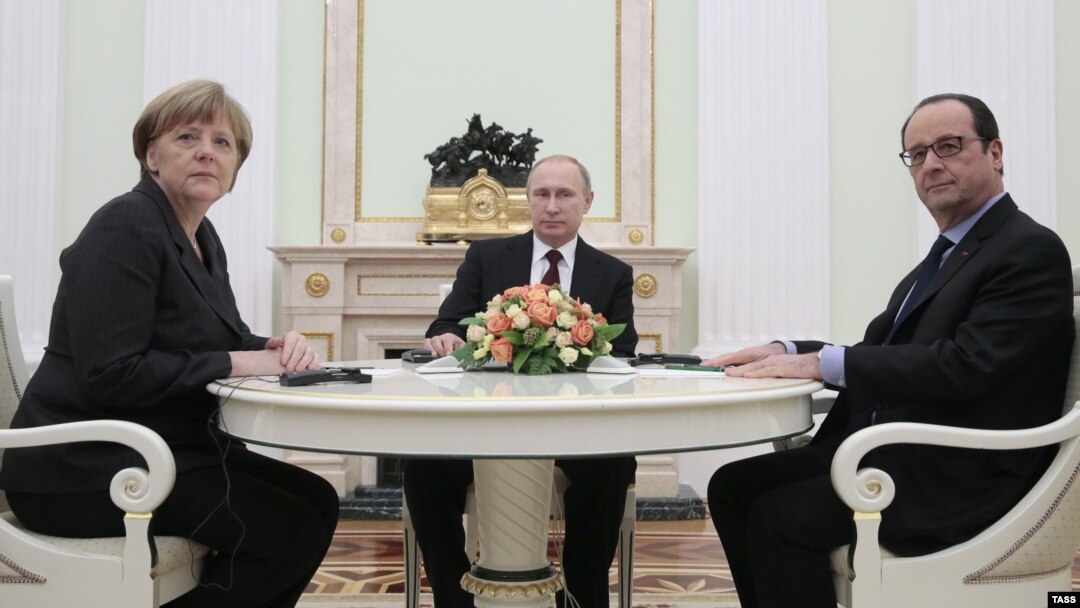 German Chancellor Angela Merkel (left to right), Russian President Vladimir Putin, and French President Francois Hollande are pictured during a meeting in the Kremlin, in Moscow, on February 6.