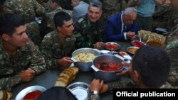 Nagorno-Karabakh - Armenian Prime Minister Tigran Sarkisian (second from right) dines with soldiers, 2Sep2013.