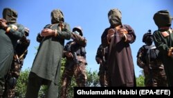 Afghan security officials escort a group of suspected Islamic State (IS) and Taliban militants who are accused of planning attacks on government and security forces in the eastern city of Jalalabad.